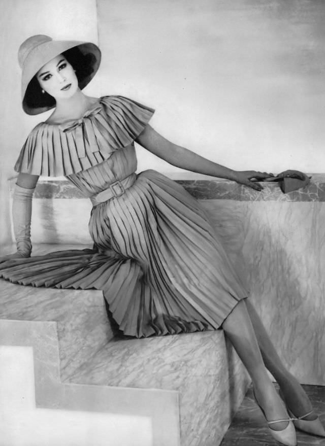 #31 Betsy Pickering in pale blue silk dress with pleated bertha collar by Yves Saint Laurent, 1959