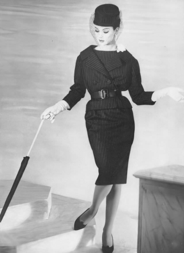 #38 Betsy Pickering in navy blue flannel suit by YSL for Dior, 1959