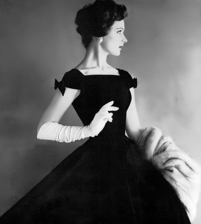 #8 Betsy Pickering in a black velveteen dress by Anne Fogarty, 1957