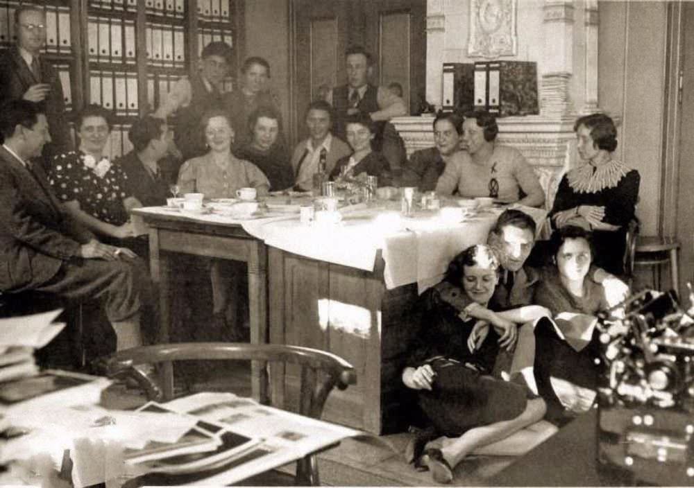 #12 Eva Braun (on floor, at left) and colleagues at the office of Heinrich Hoffmann’s photo agency, Munich, Germany, 1938.