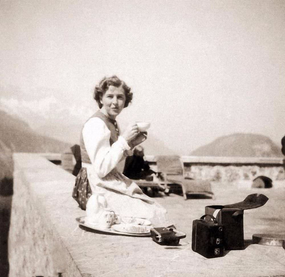 #18 Eva Braun sits on the terrace at Berghof, Hitler’s home in the Alps, 1942. A photography buff, she took many photos of daily life at Berghof; note the camera by her side. But her life would not long remain so idyllic.