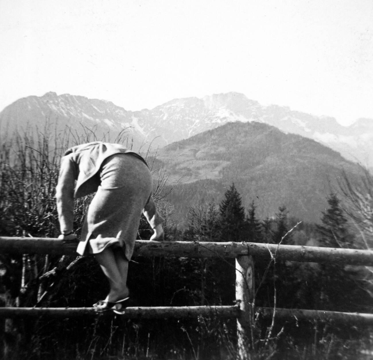 #39 Eva Braun climbing a fence in 1930s or 1940s Germany