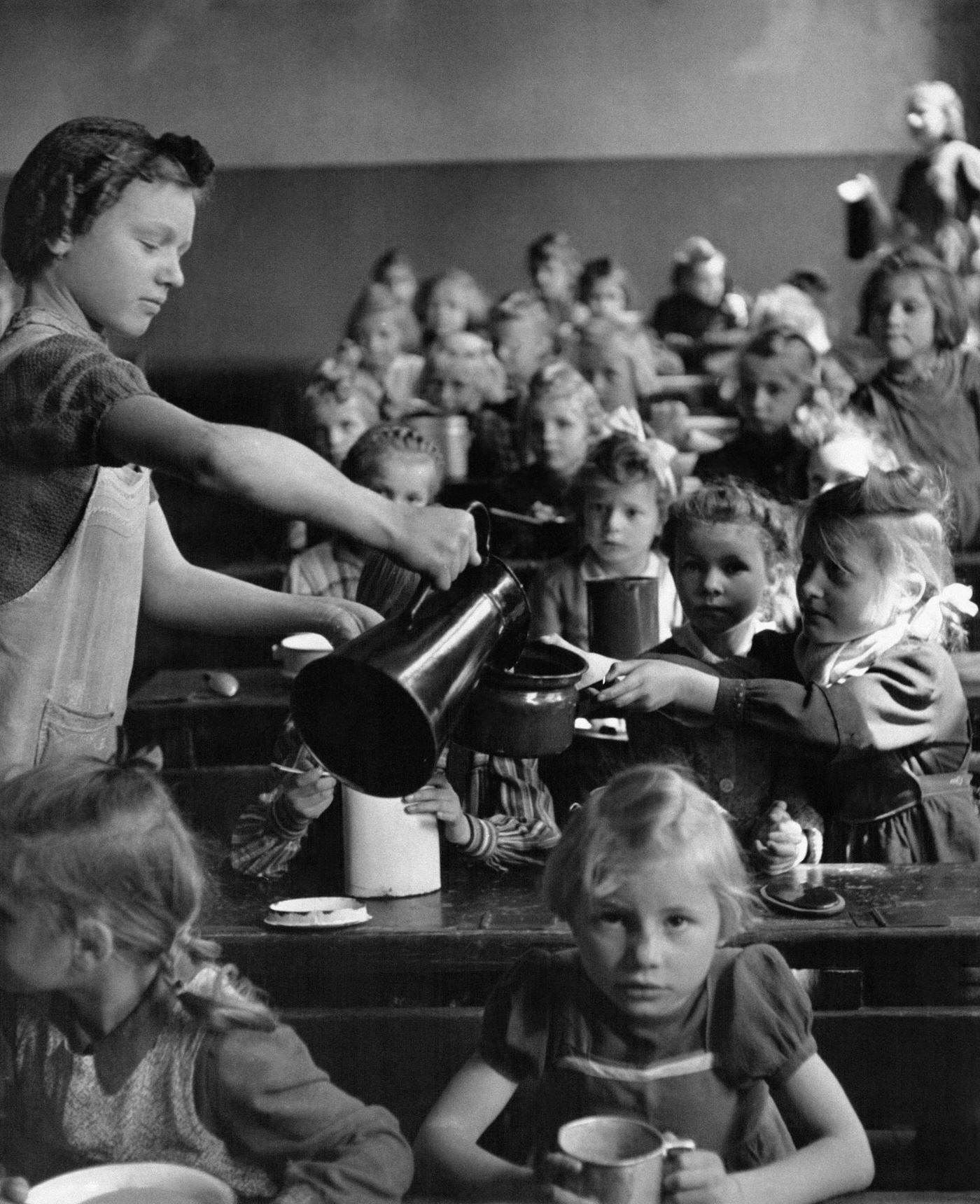 #77 Germany: Sport in the Third Reich – Members of the ‘League of German Girls’ jogging at the Reichssportfeld in Berlin, 1940.