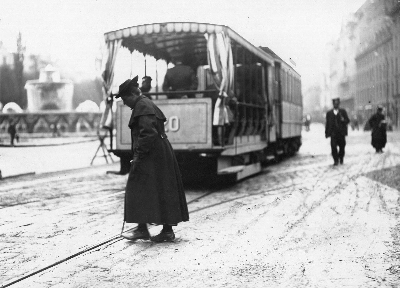 #21 Woman changing points for the tram, Munich, Germany, around 1900.
