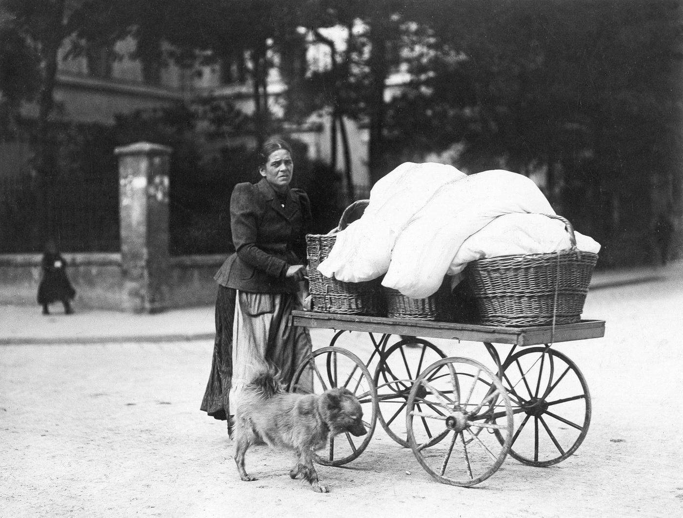 #22 Washerwoman pushing a cart, Munich, Germany, around 1900.