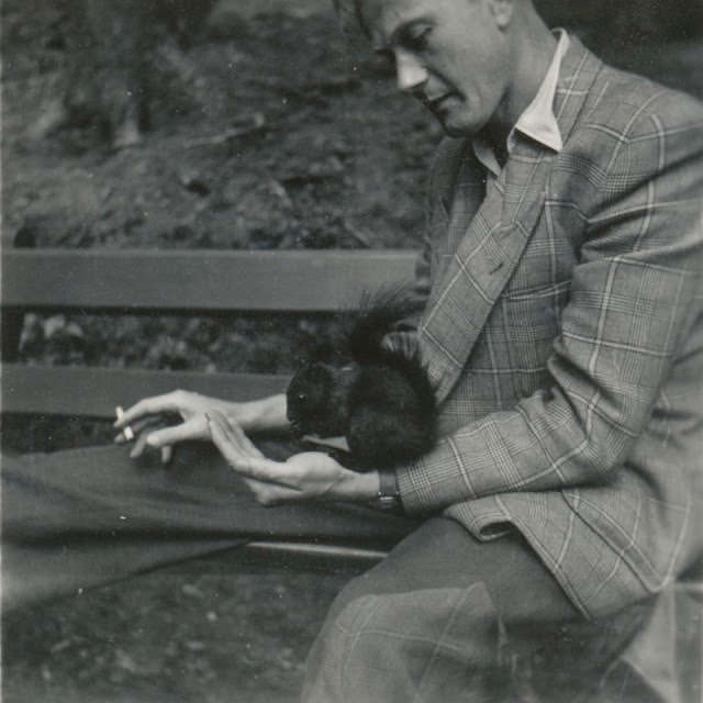 #25 Channeling Le Samouraï. Instead of a small bird in a cage, he’s got a squirrel friend in the park, Germany, circa 1950s