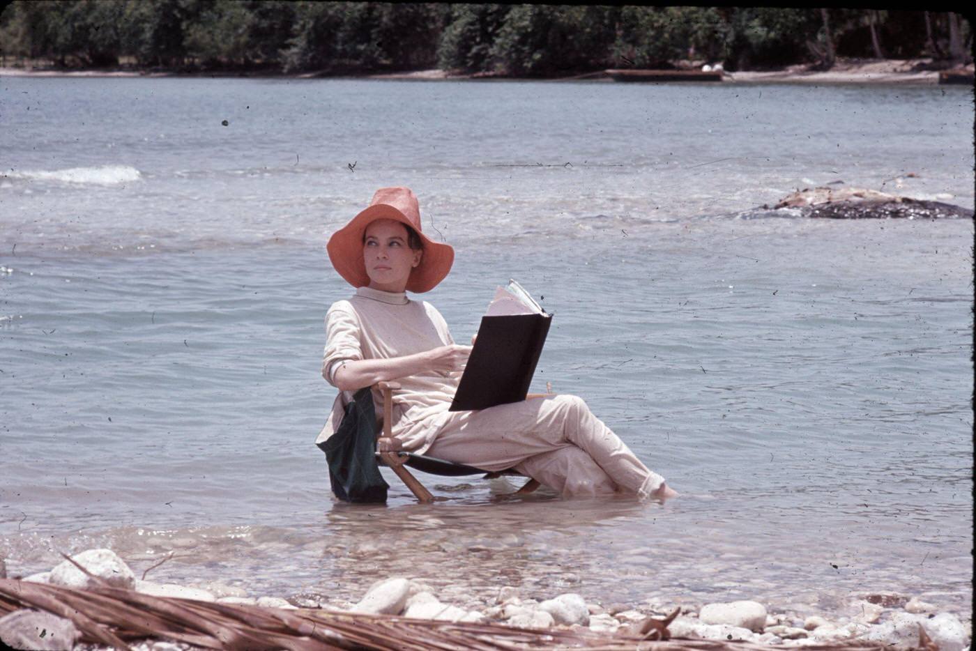 #57 Leslie Caron reading in the ocean for “Father Goose,” Ocho Rios, St. Ann, Jamaica, 1963