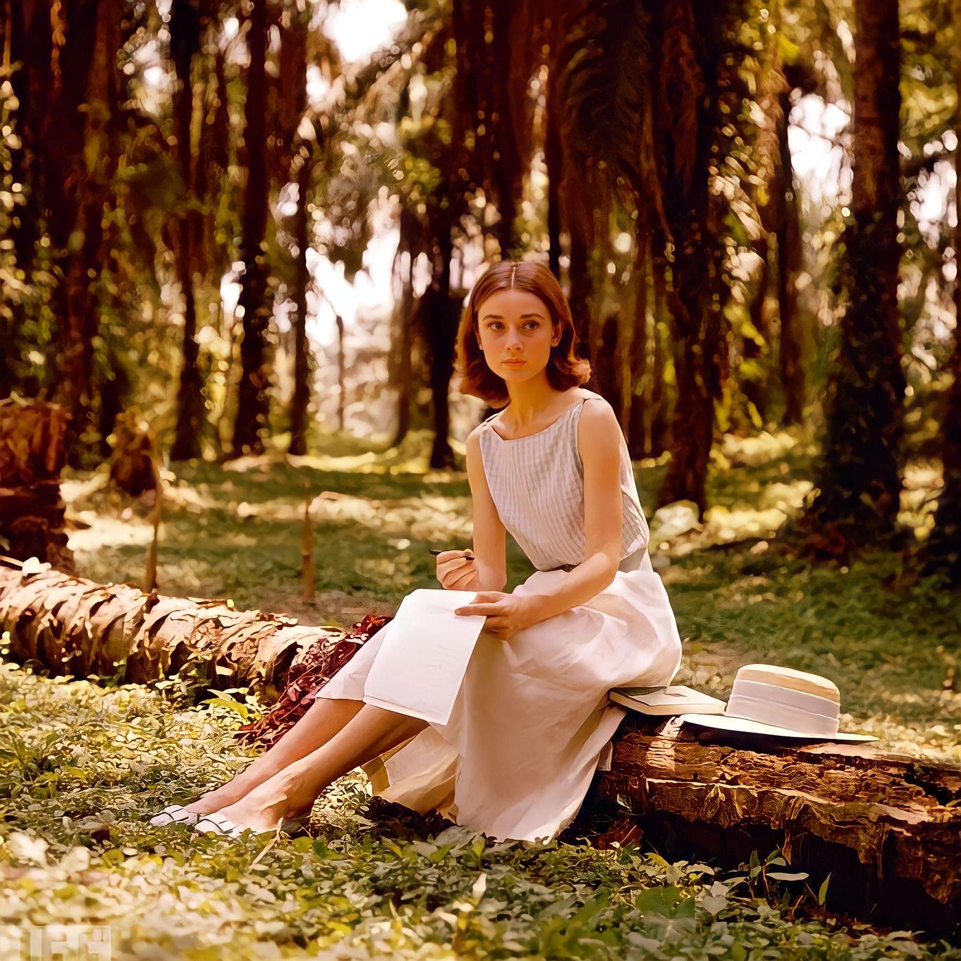 #79 Audrey Hepburn sits on a log while writing a letter in the Congo jungle where she was filming “The Nun’s Story,” 1958.