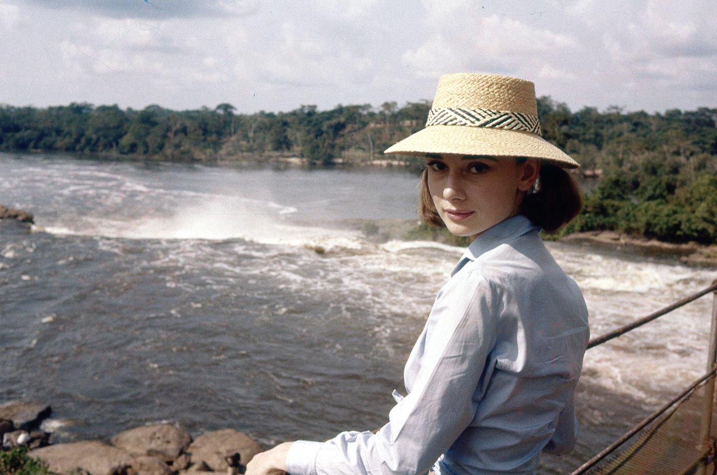 #84 Actress Audrey Hepburn crossing a river bridge in Congo, 1958.