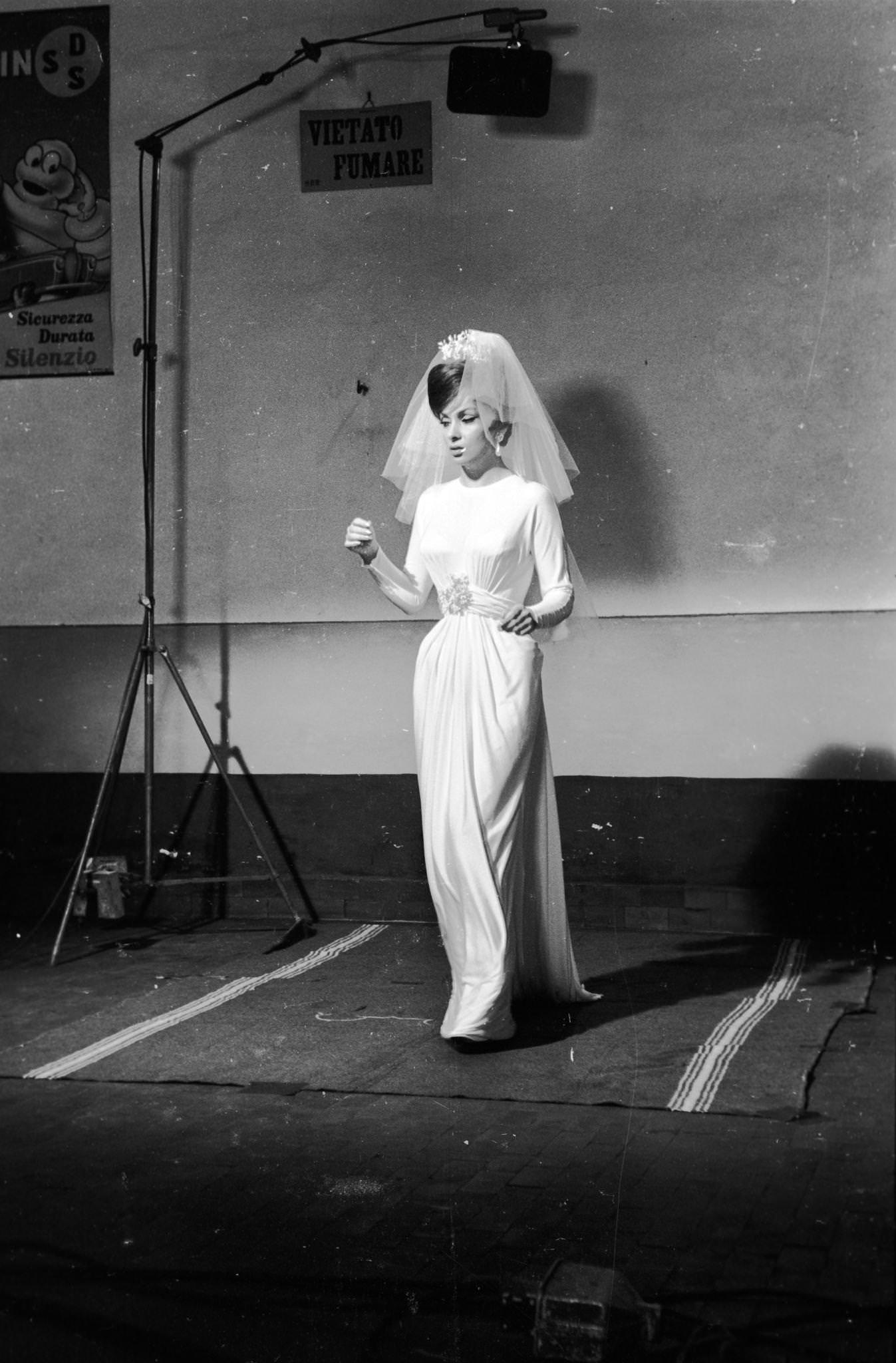 #96 Gina Lollobrigida dressing as a bride for “Come September” in Roma, Italy, 1960.