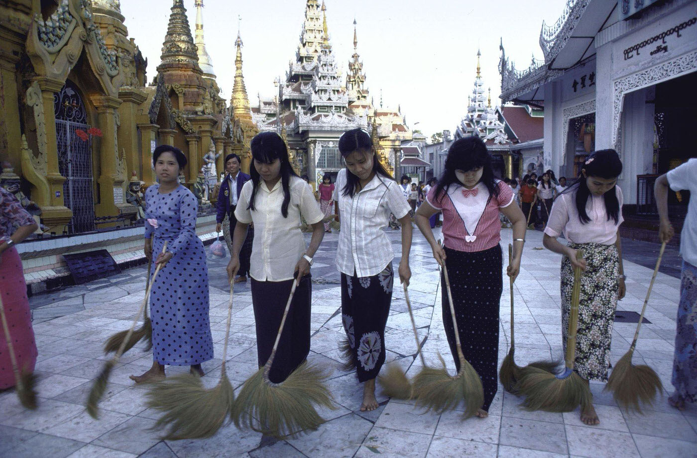 #5 Barefooted Women Using Large Feather Dusters to Clean Sidewalk Outside of Shwe Dagon Pagoda