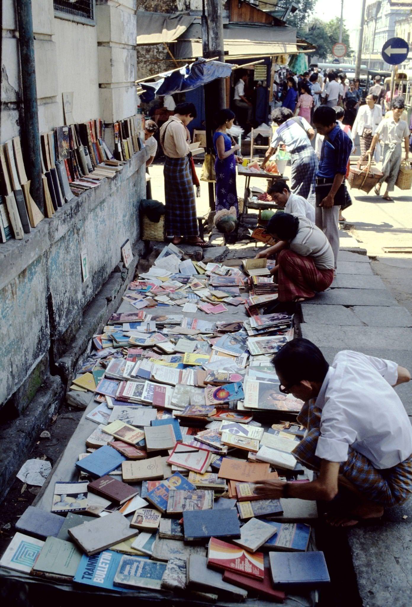 #28 Street Vendor Offers Pre-Owned Magazines and Books at a Kerb-Side Stall in Rangoon, Burma, 1985