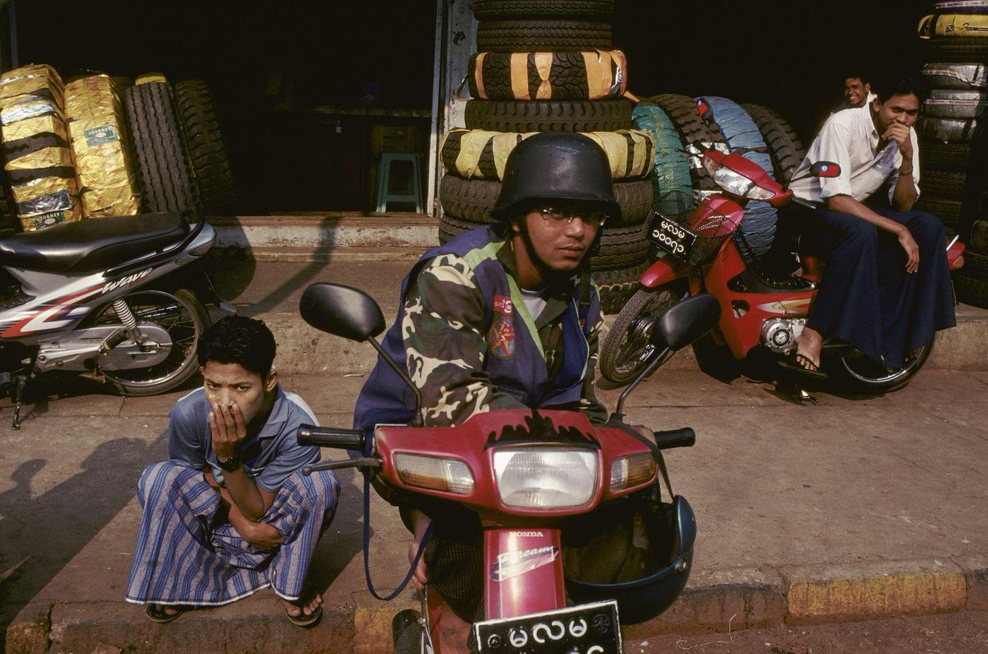#62 Myanmar – Man on a Motorcycle Wearing Copy of SS German Helmet at Moulmein, 1980s