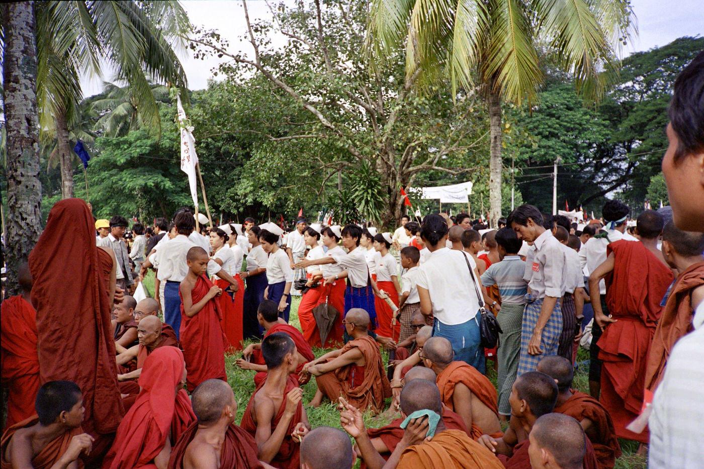 #18 Buddhist monk and Burmese demonstrators at a rally led by Aung San Suu Kyi in Yangon, 1988.