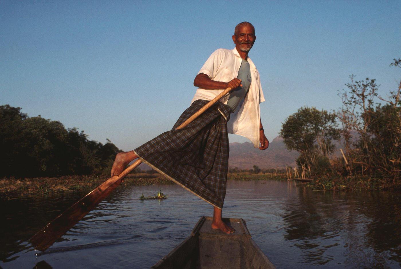 #69 Maung Oo, a boatman leg rowing on Inle Lake in Burma, 1988.