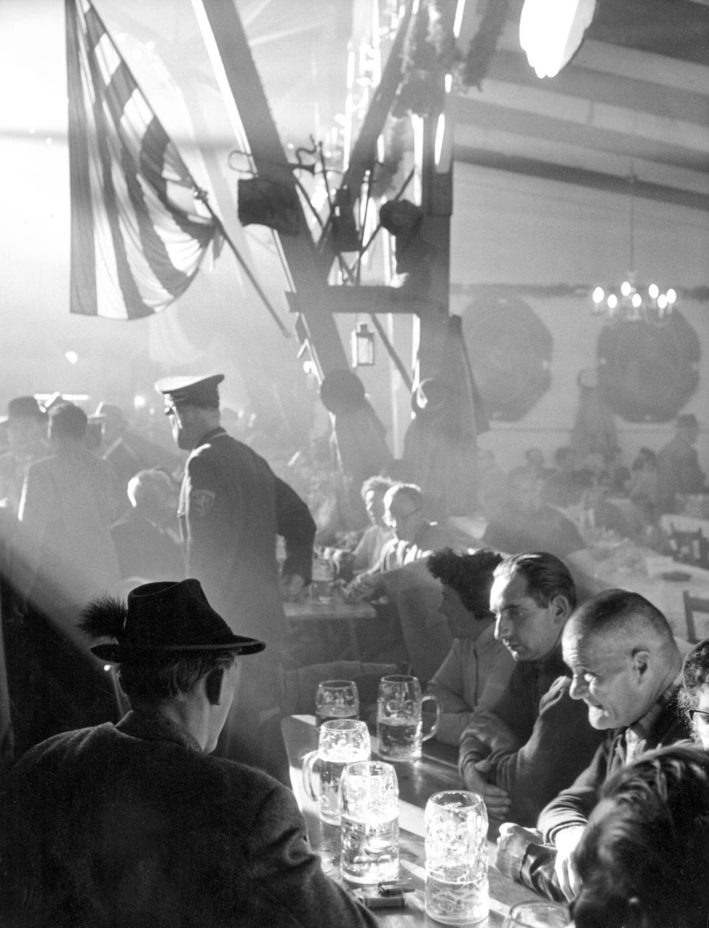 #12 Atmosphere of Oktoberfest with beer and food, 1961.