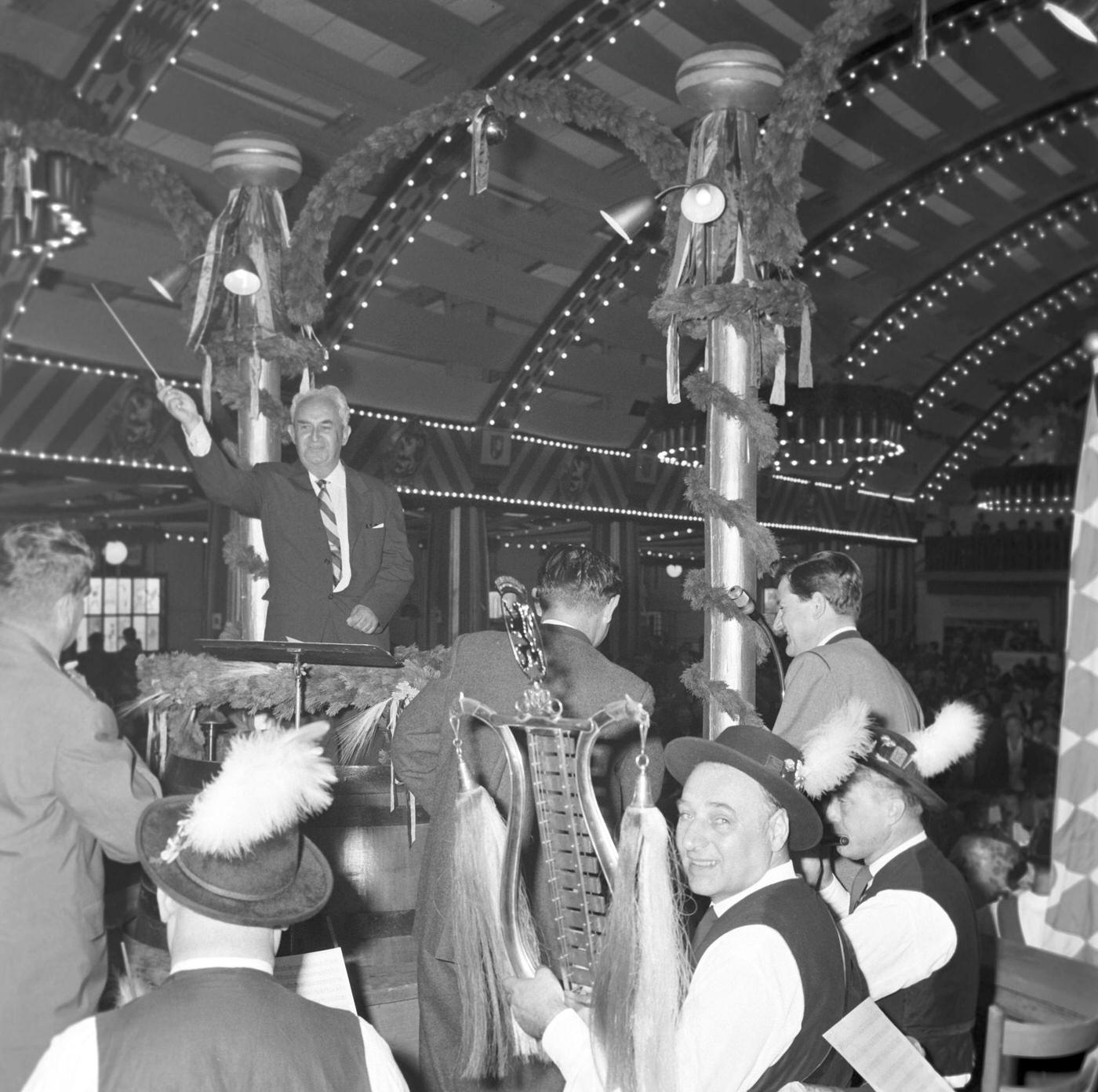 #23 Composer Walt Erdale conducts brass band at Oktoberfest, 1963.