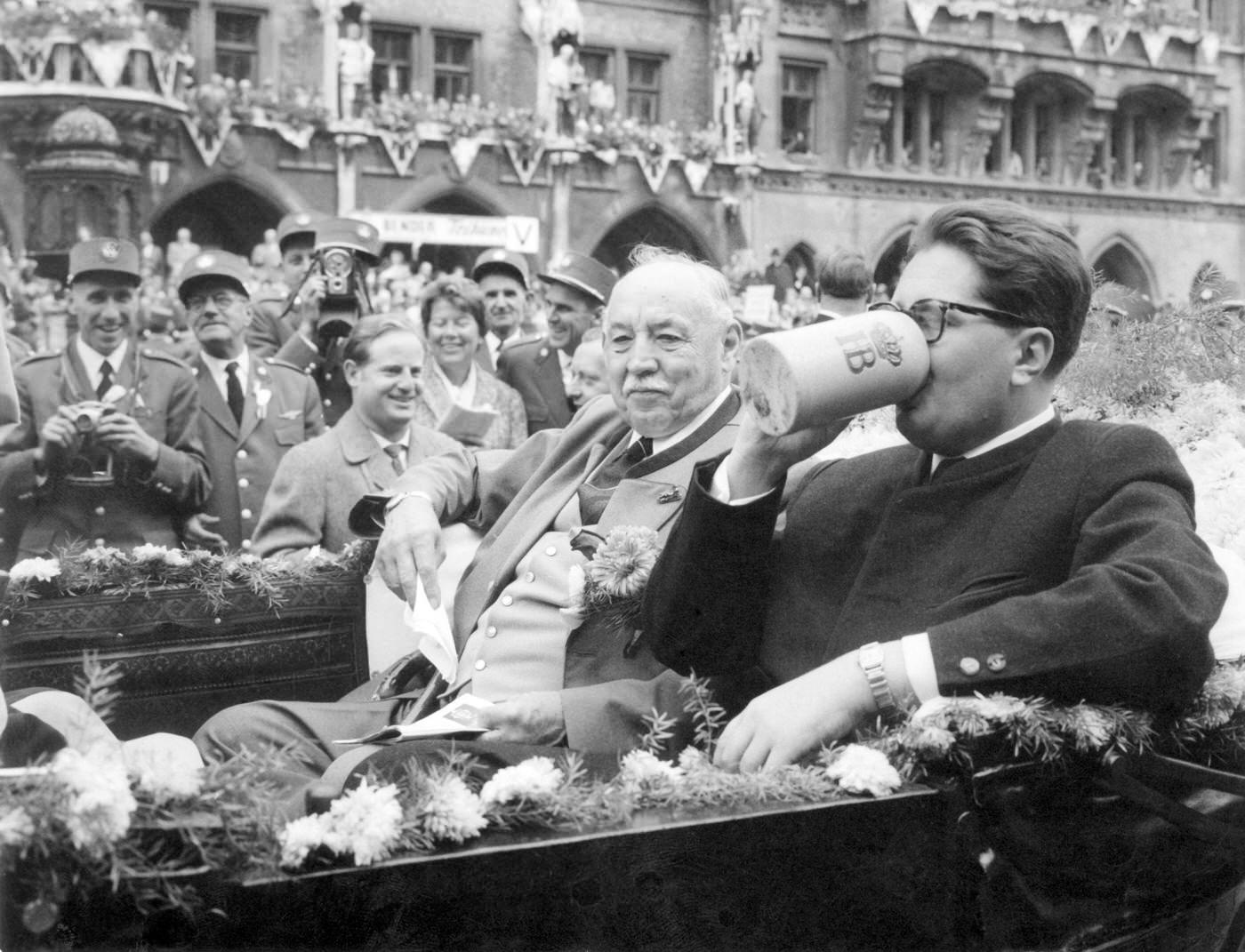 #8 Mayor Hans-Jochen Vogel refreshes at Oktoberfest parade, 1960.