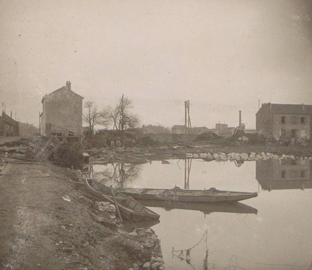 #124 Boat and houses in a flooded suburb of Paris. Part of photo album of the 1910 flooding in Paris and suburbs.
