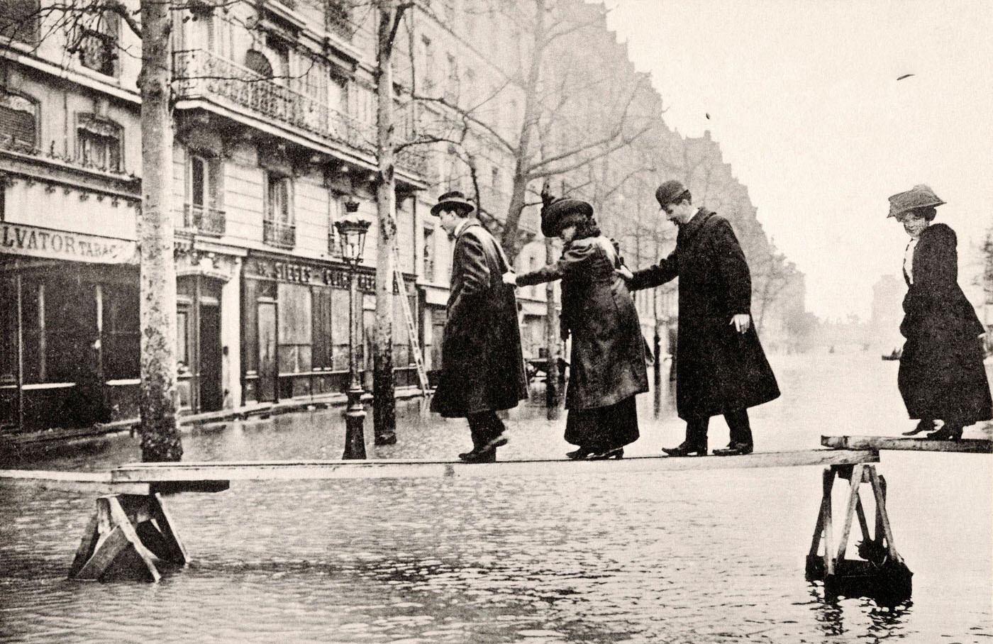 #18 Vintage French postcard: pedestrians crossing flooded Seine River at Avenue Ledru-Rollin, Paris, circa January 1910.