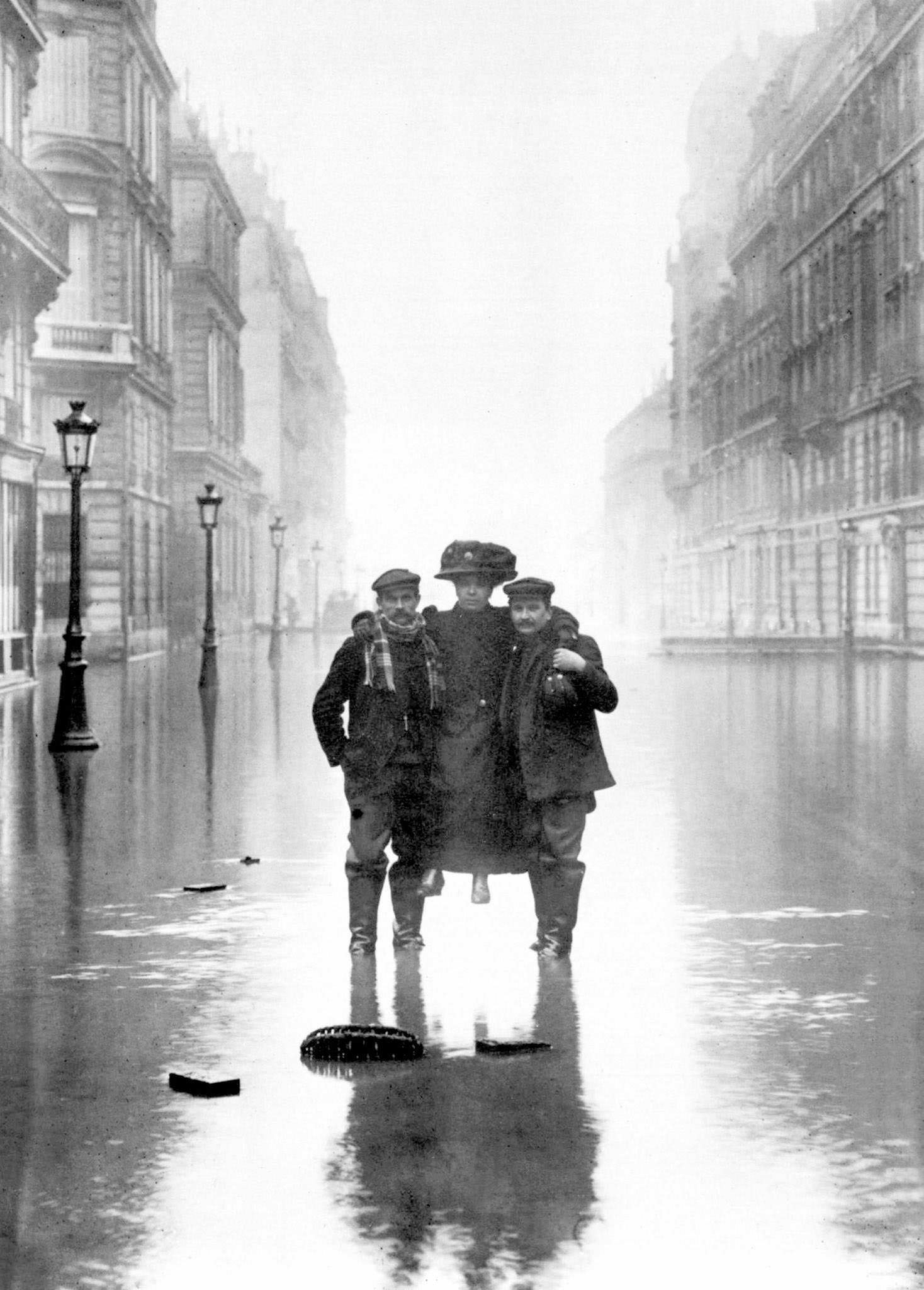 #3 Men carrying a woman during floods in Paris, 1910.