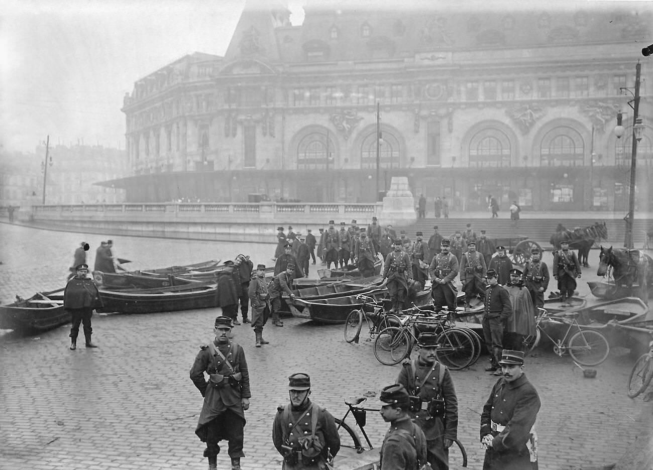 #62 Historic flooding of Paris, 1910 – Army engineers with boats in front of Gare de Lyon.