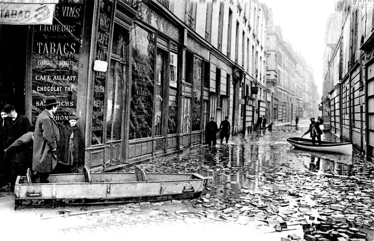#68 10th-century flooded Paris street with rowing boats, France, 1910.