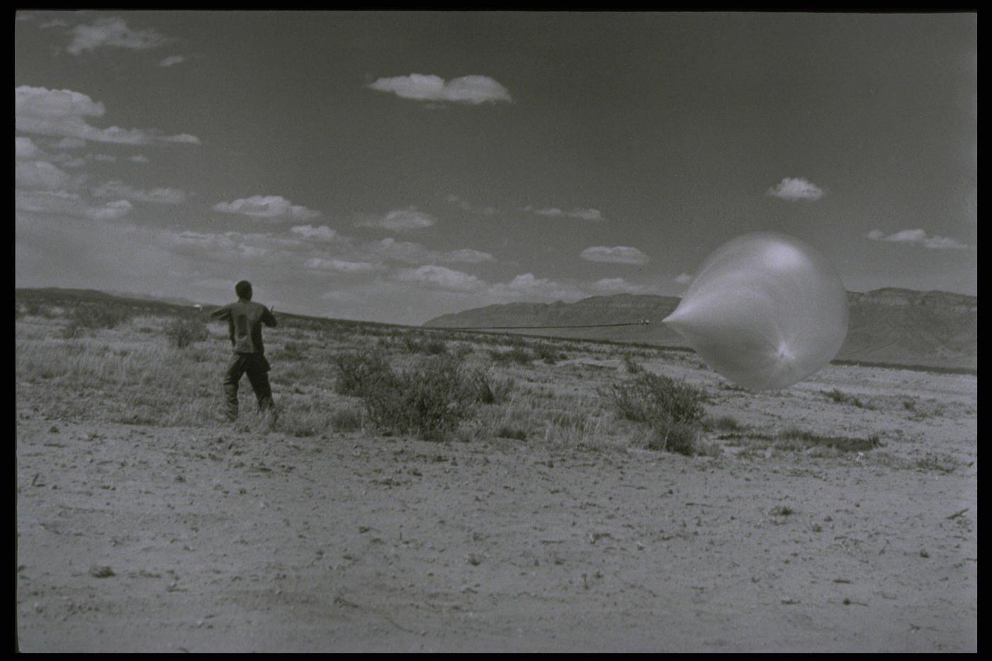#24 Man Holding Research Balloon in Desert, New Mexico