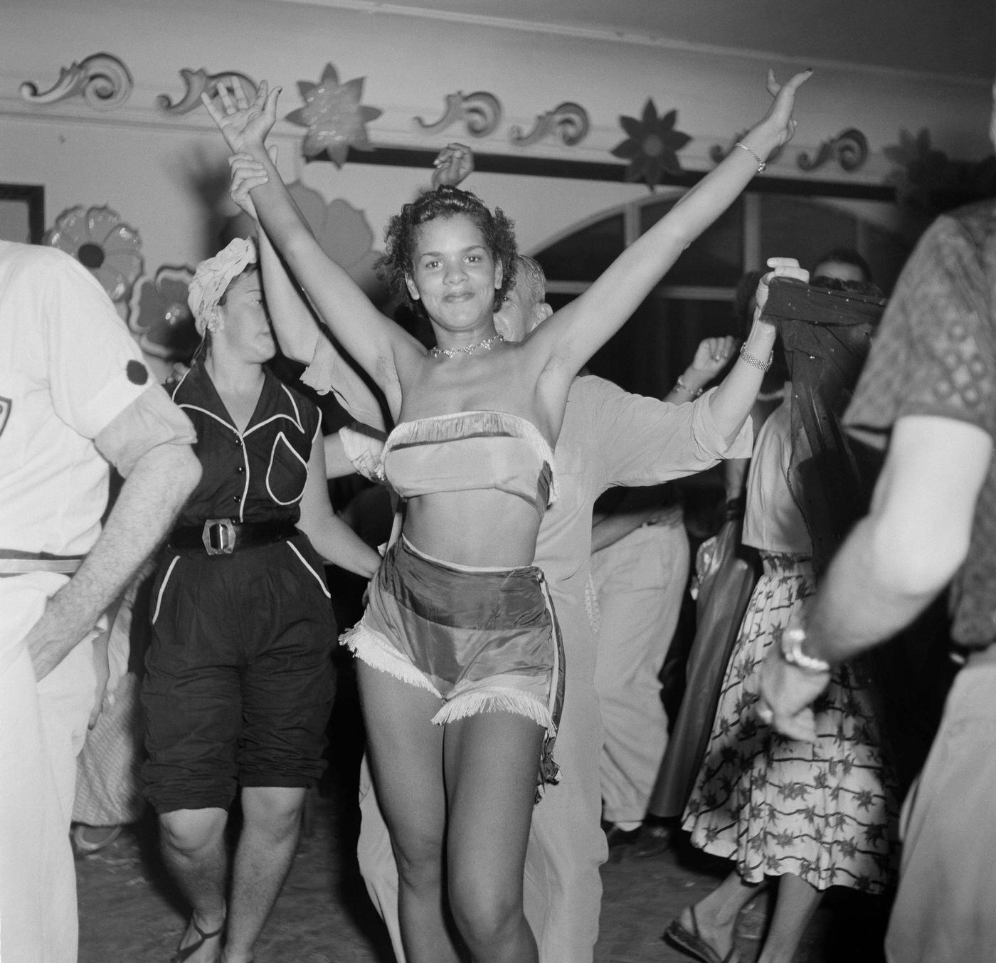 #101 Parade reveler poses at a party during Rio de Janeiro’s Carnival. 1953
