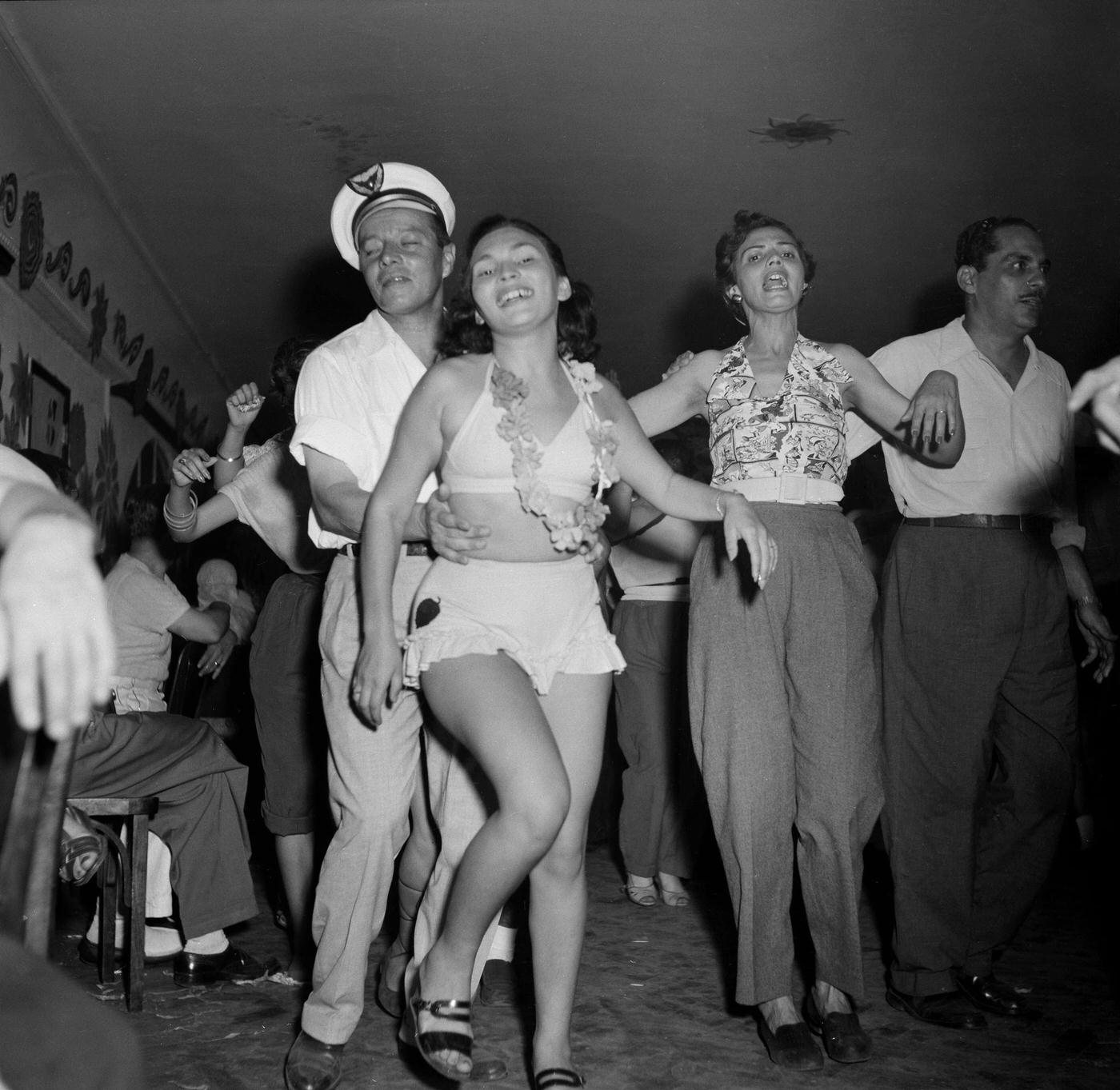 #93 Carnival parade revelers in costumes party in Rio de Janeiro’s Carnival. 1953