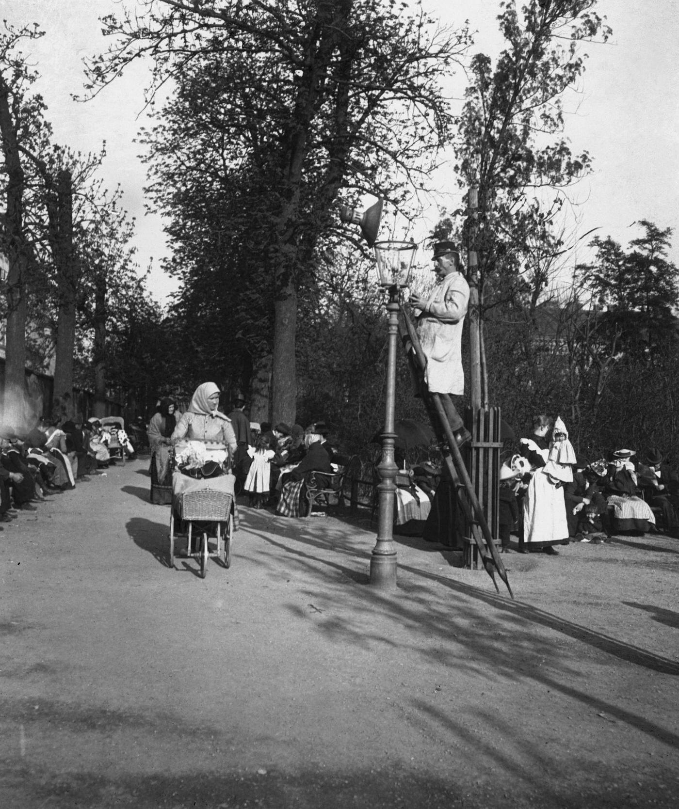#44 Governesses and Children in a park in Vienna, A man is cleaning a street lamp, Vienna, 1900s