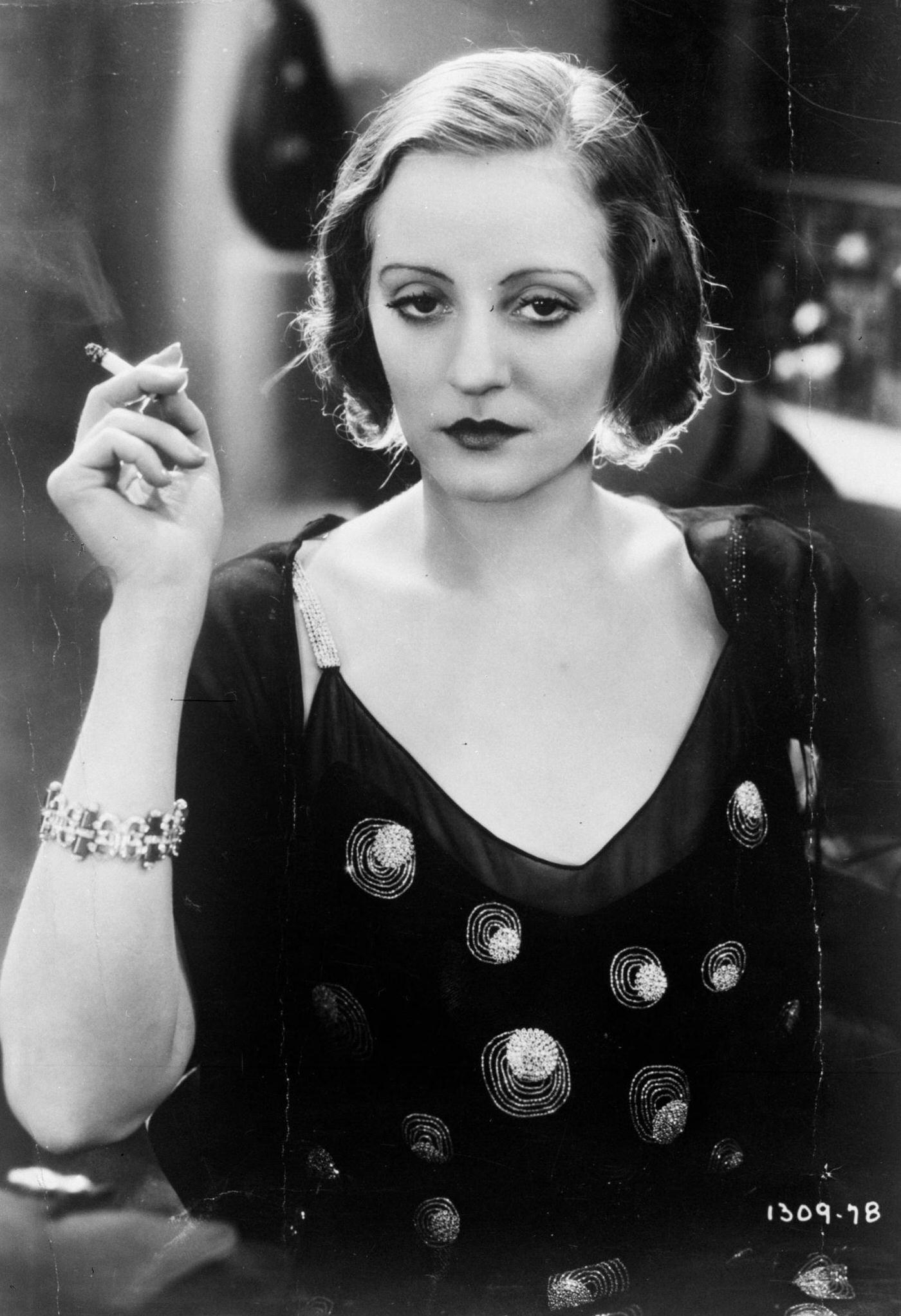 #22 Actress Tallulah Bankhead having a sultry smoke, 1968.