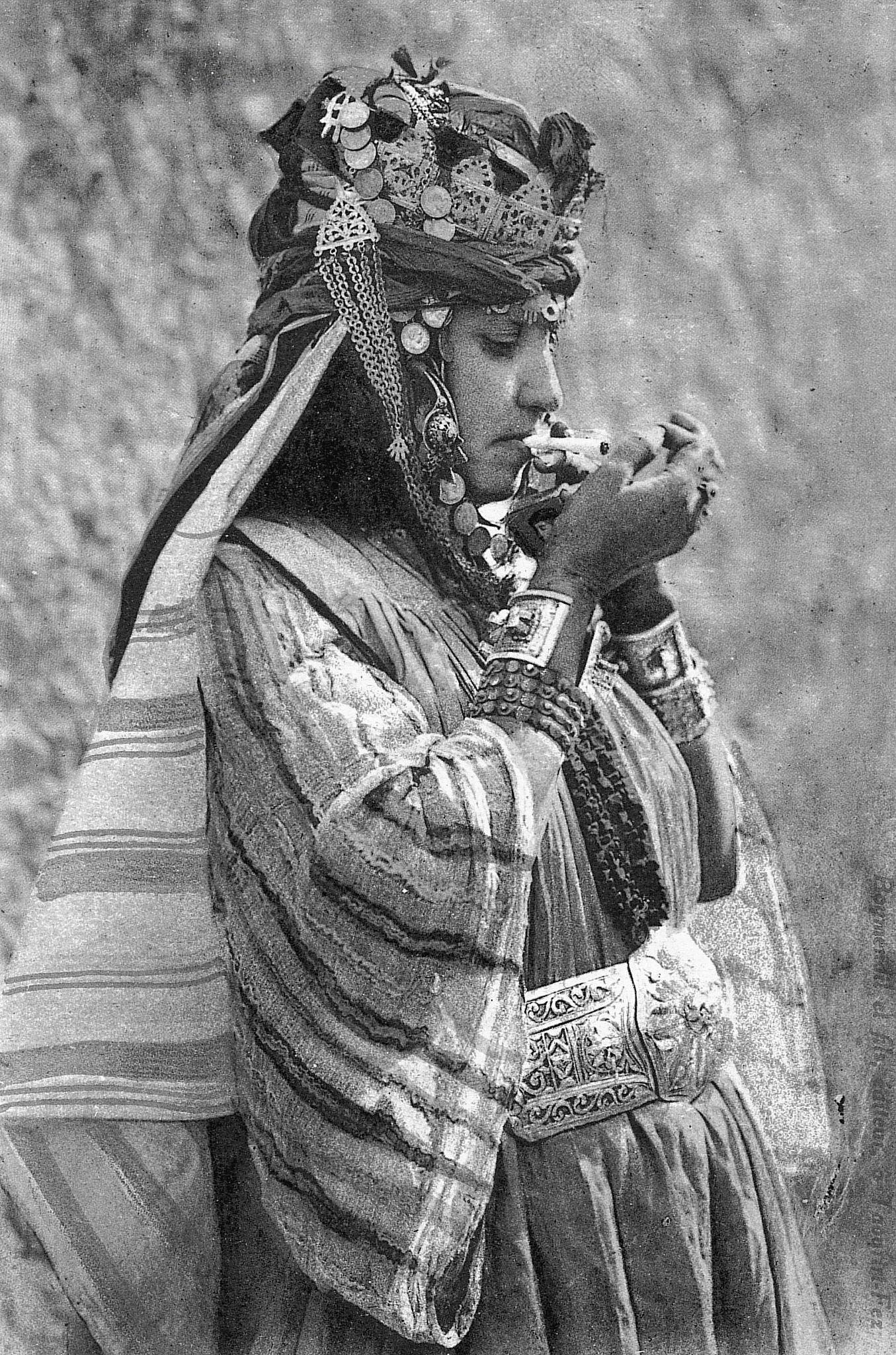 #34 Traditional dressed Moroccan woman smoking a cigarette, 1930.