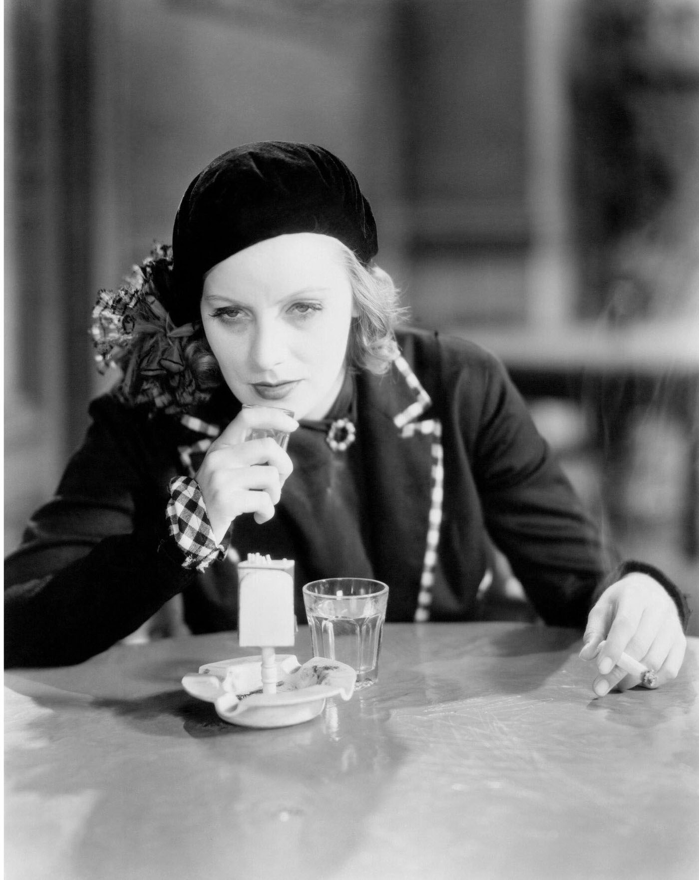 #37 Swedish Actress Greta Garbo drinking whiskey and smoking a cigarette in ‘Anna Christie’, 1930, United States.
