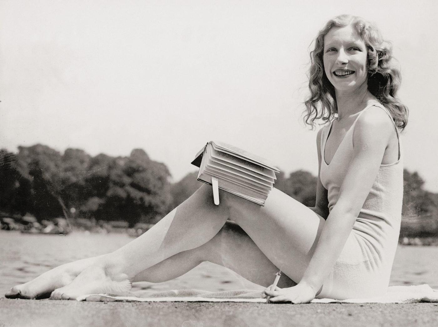 #42 Sunbathing girl in her bathing suit in Hyde Park, London, smoking a cigarette and reading a book, 1932