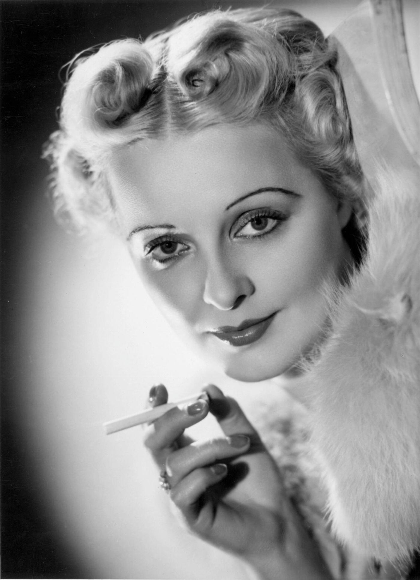#74 British actress Jean Colin reclines in a seductive pose, 1937