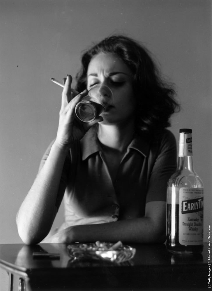 #11 Aspiring actress Jean turns to drink to drown her sorrows after another unsuccessful day looking for work in New York, circa 1955.