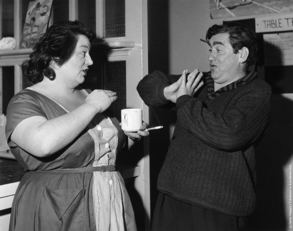 #23 English actor and comedian Tony Hancock shares a joke with actress Hattie Jacques during a break from the “Hancock’s Half Hour” rehearsals. 21st October 1959.