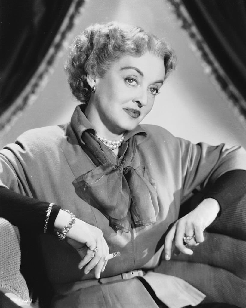 #29 Bette Davis smoking in a scene from ‘Payment on Demand,’ 1950.