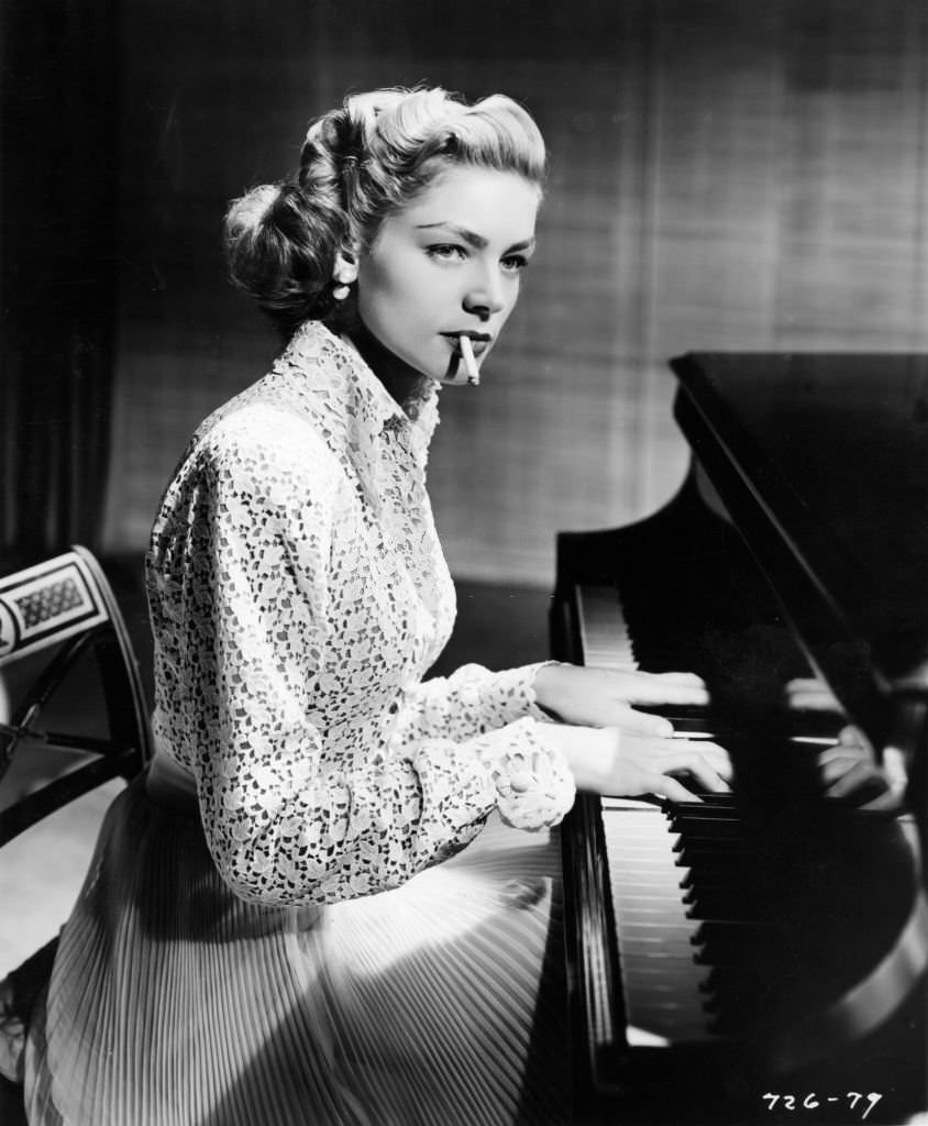 #34 Lauren Bacall smoking as she plays piano in ‘Young Man with a Horn,’ California, 1950.