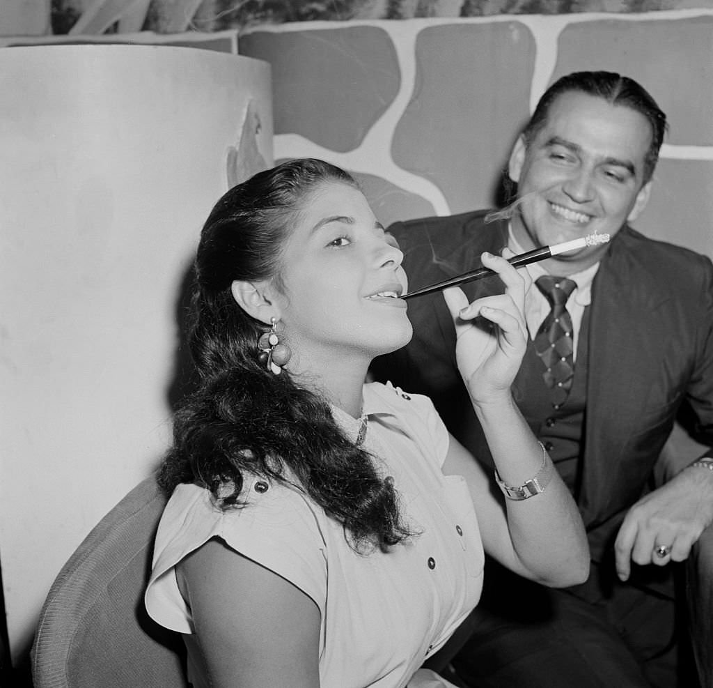 #35 A woman smokes a cigarette in a local restaurant in Rio De Janeiro, Brazil, circa 1950.