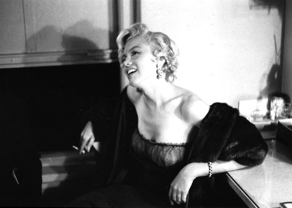 #56 Marilyn Monroe smoking a cigarette backstage at a Broadway Theater in New York, 1954.
