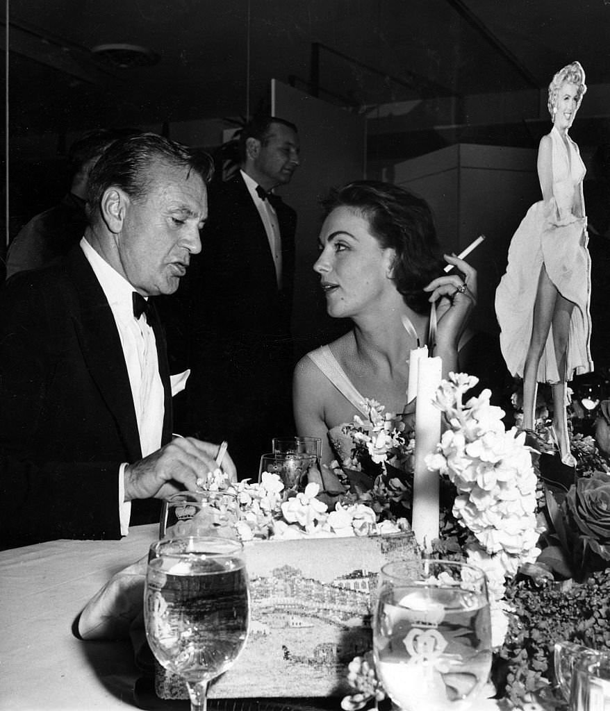 #57 Gary Cooper with Hjordis Tersmeden at the wrap party for “The Seven Year Itch,” Los Angeles, 1954.