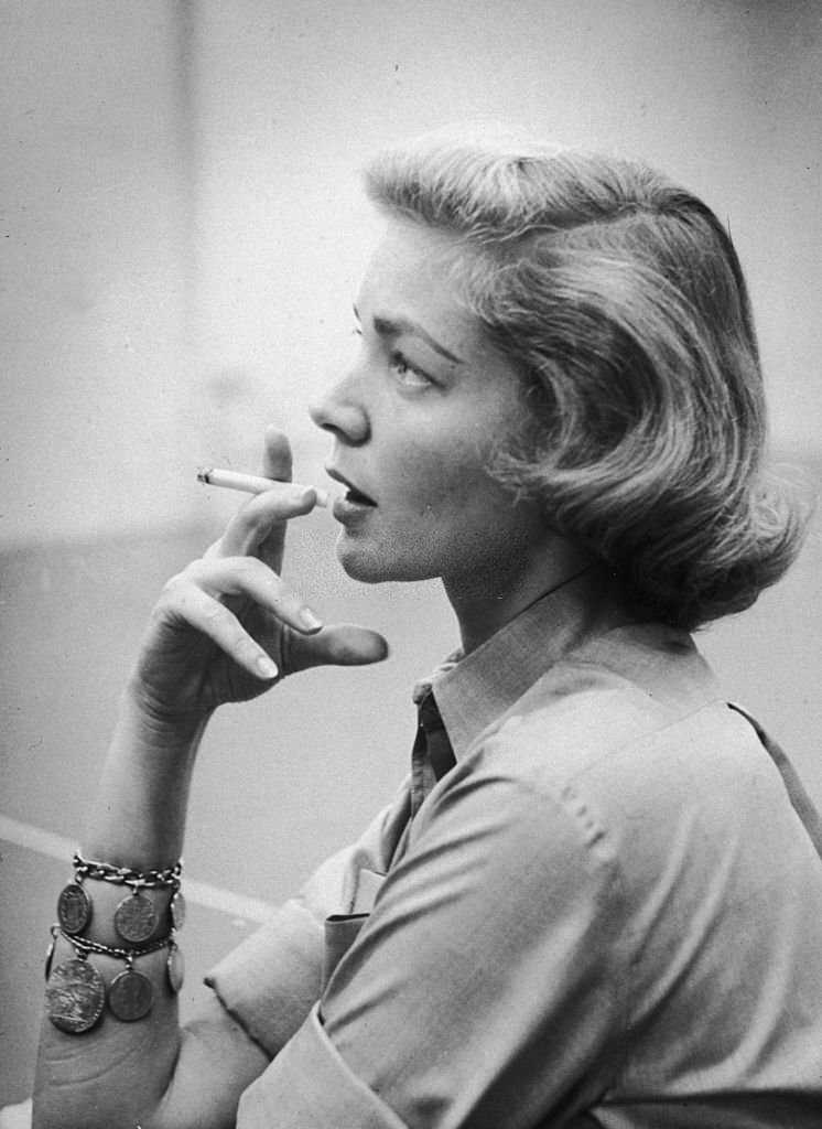 #65 American actress Lauren Bacall smoking a cigarette during a rehearsal break in Hollywood, California, circa 1955.