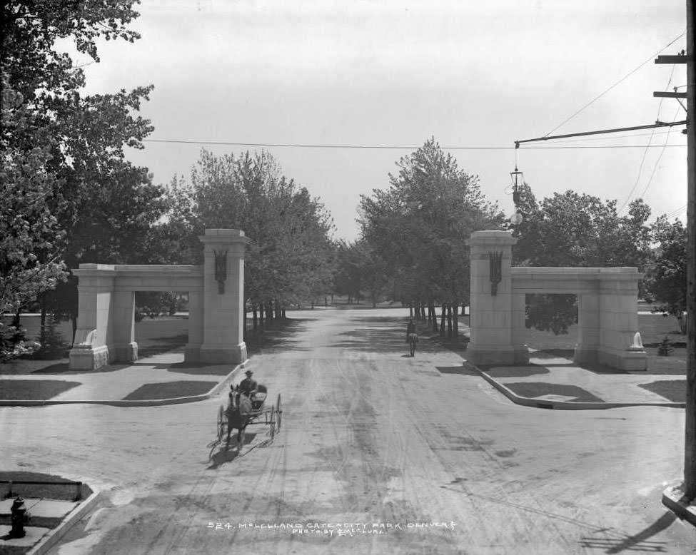 #107 View of McLellan Gate at City Park, Denver, horse-drawn buggy and streetlight visible, 1904