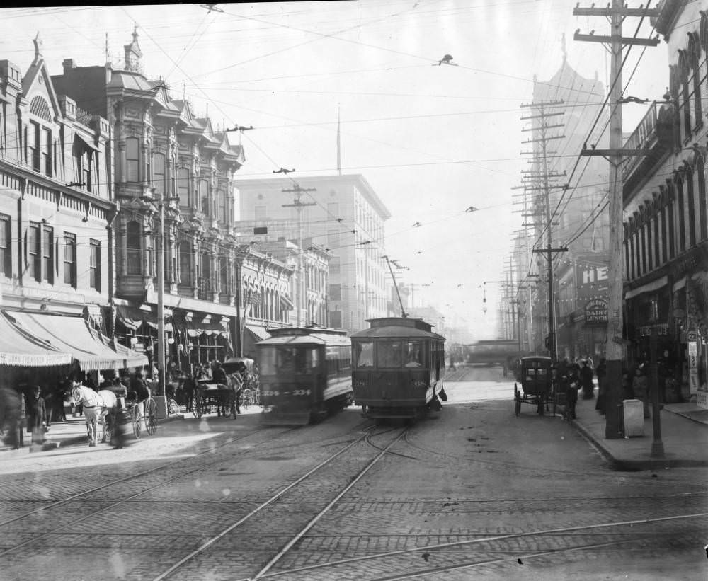 #142 Denver Tramway trolleys on 15th Street featuring signs like “John Thompson Grocery Co.”, 1905.