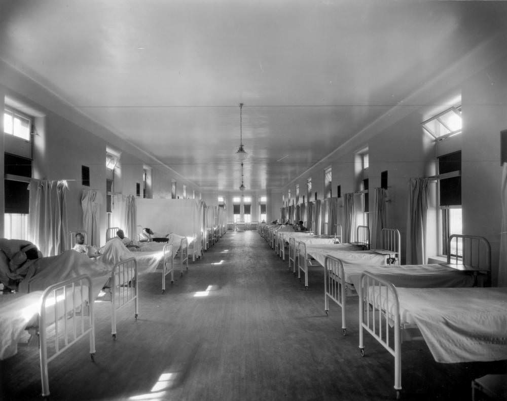 #31 Men in a ward of Denver General Hospital with empty beds and curtains, 1900s