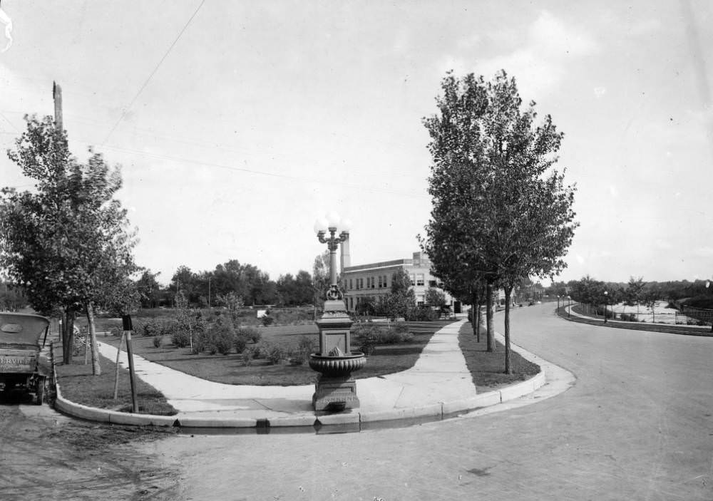 #50 Intersection of Speer Boulevard and Lincoln Avenue, featuring a horse trough and landscaping, Denver, 1900s