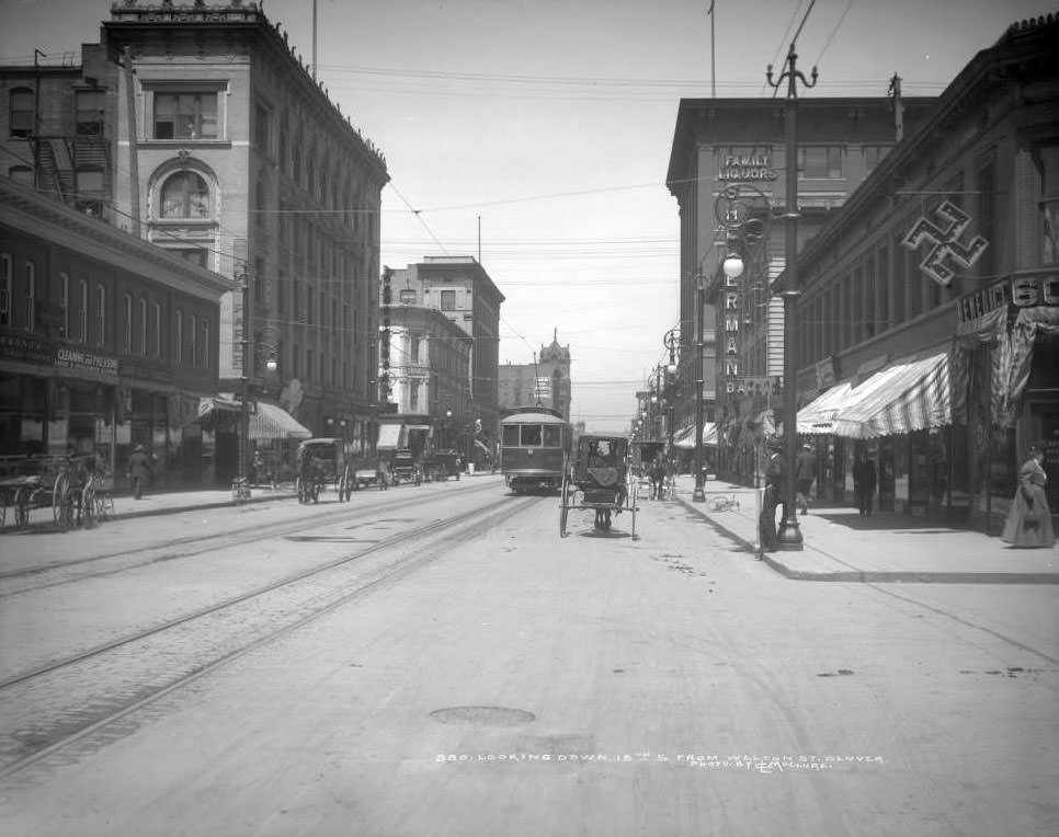 #69 View down 15th Street from Welton, featuring various modes of transport, 1900