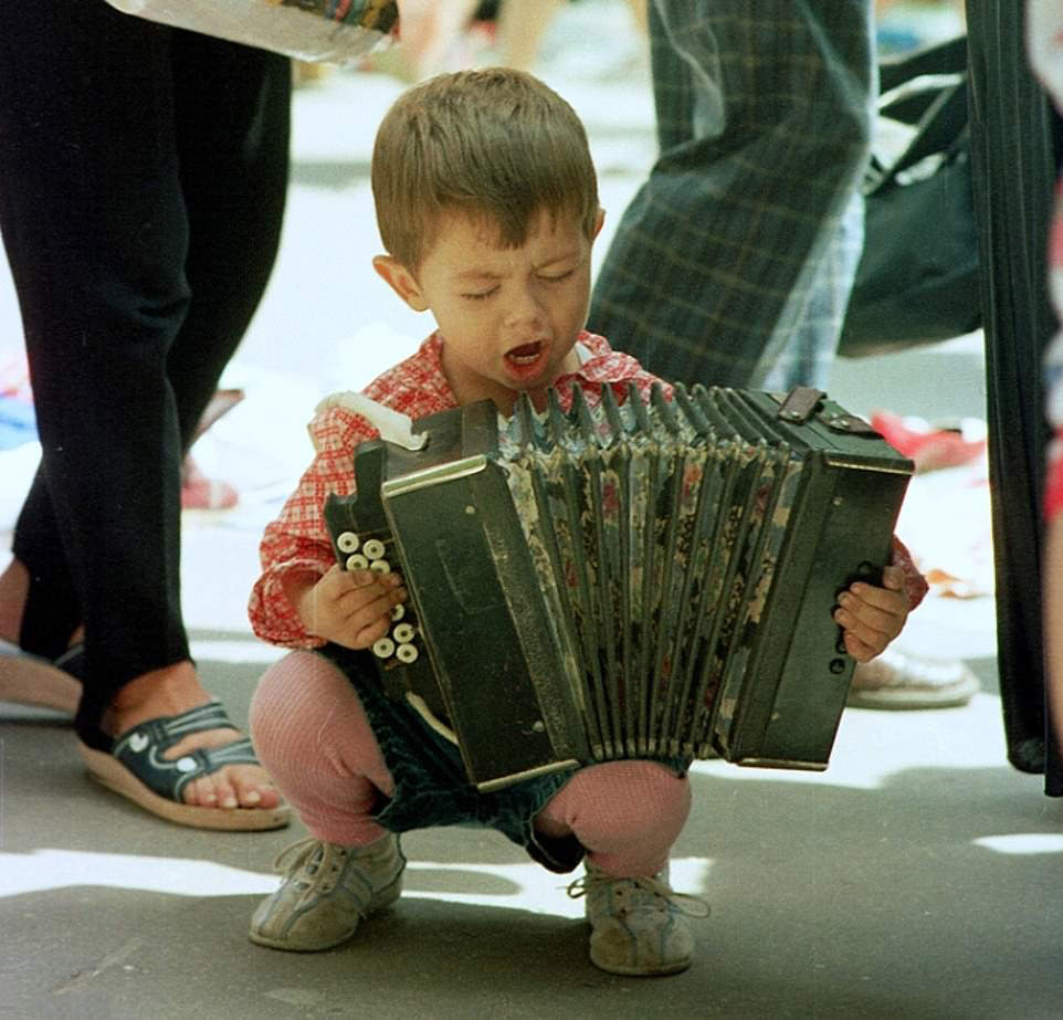 #3 Street Musician: A young boy impresses with his accordion skills on the streets of Kyiv, 1998.